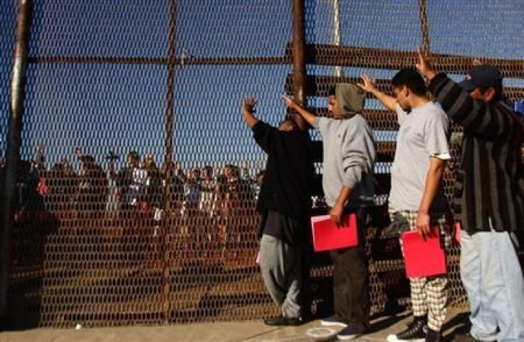 Recently deported immigrants gathered at the border between San Diego and Tijuana in 2011.