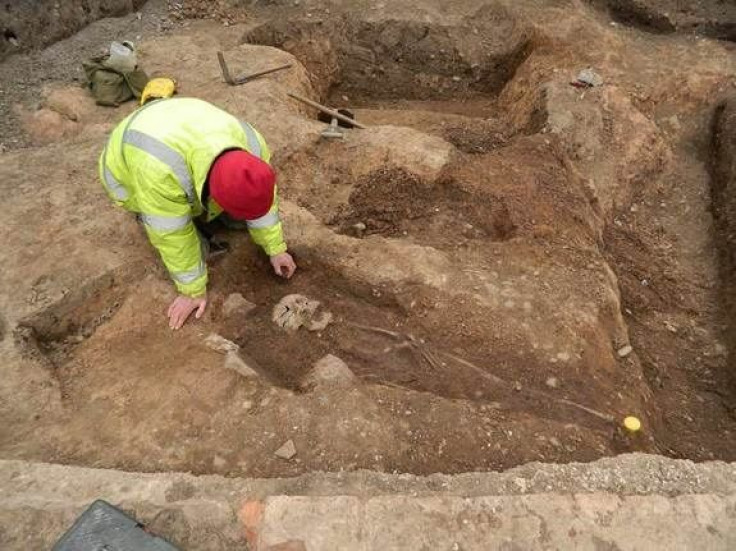 Archaeologist excavating burials in Leicester, England parking lot
