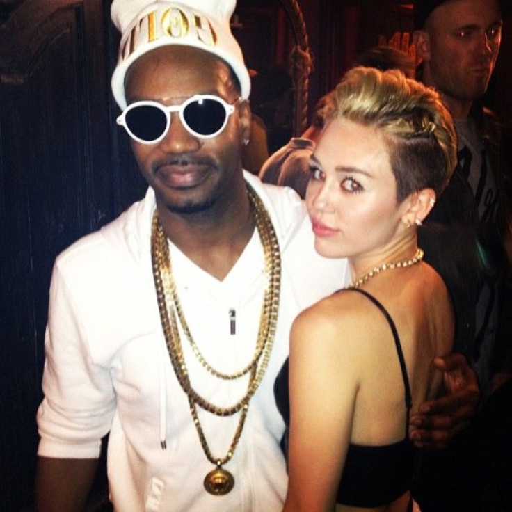 Miley Cyrus and Juicy J pose after the LA concert.