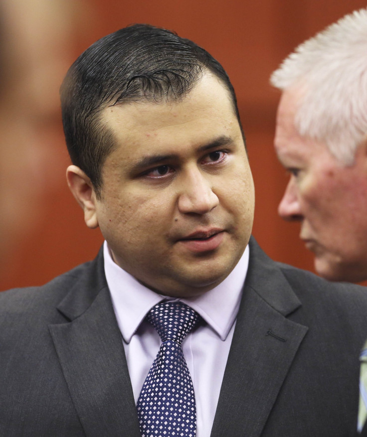 George Zimmerman talks to court security investigator Robert Hemmert after the jury leaves the courtroom for more deliberations in Sanford.