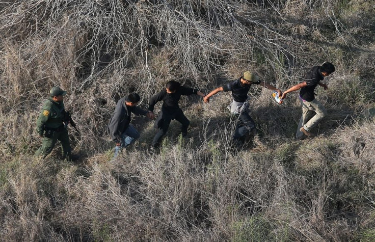 A Border Patrol agent escorts a group of undocumented immigrants in the Rio Grande Valley.