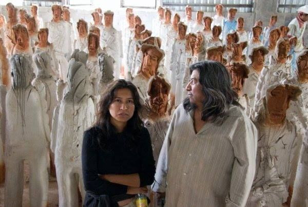 Santiago, right, and a few of his clay migrants.