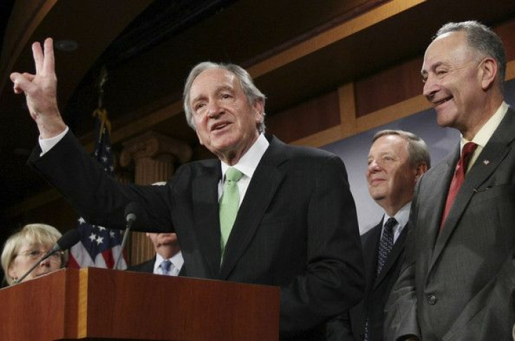 Sen. Tom Harkin (D-Iowa) gives the victory sign as he stands with other Senate Democrats in 2009.  