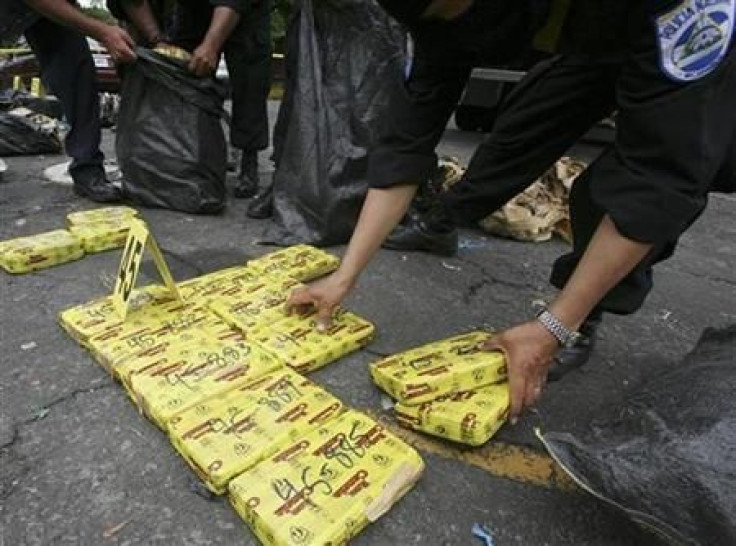 Costa Rican police lay out packages of cocaine at a media event in 2008.