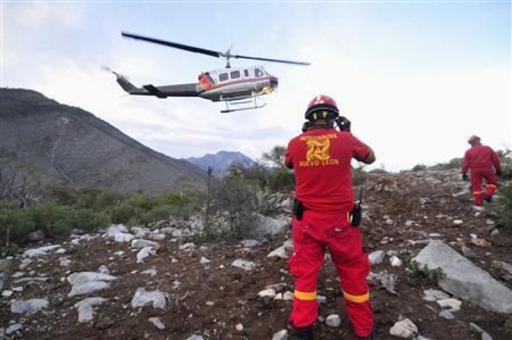 Civil Protection personnel inspect the perimeter of the crash site of a plane with Mexican-American singer Jenni Rivera on board, in the municipality of Iturbide, south of Monterrey December 9, 2012. 