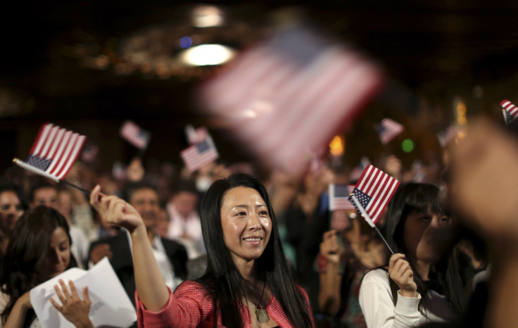 A woman waves a flag during a U.S. Citizenship and Immigration Services naturalization ceremony in Oakland.