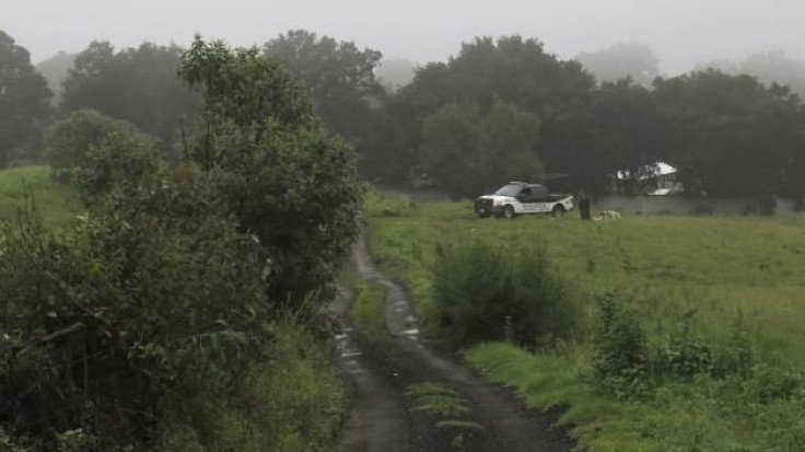 A police vehicle at the ranch where the mass grave was found.