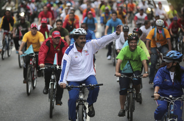 Maduro waves to the crowd as he and his fellow riders take a spin around the center of Caracas.