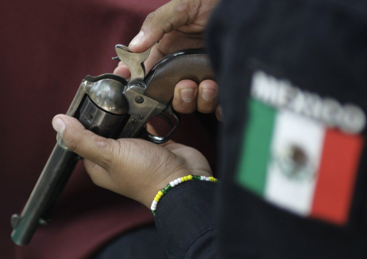 A Mexico City police officer checks a gun handed in as part of a voluntary disarmament program.