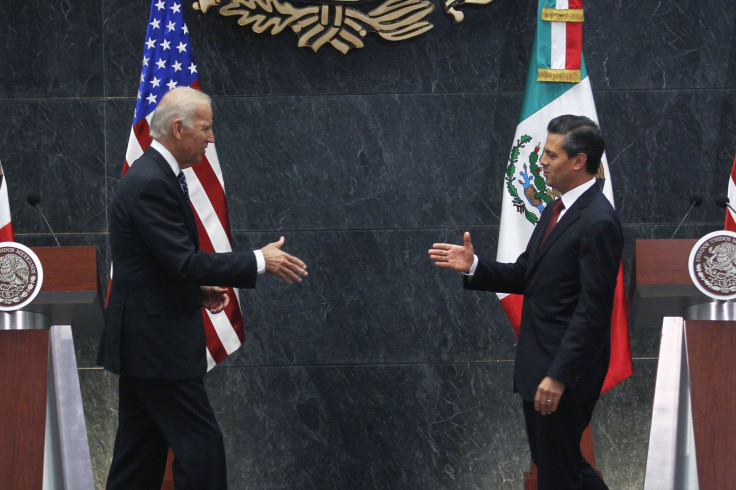 Biden and Mexican president Enrique Peña Nieto go to shake hands after meeting in the presidential palace on Friday.