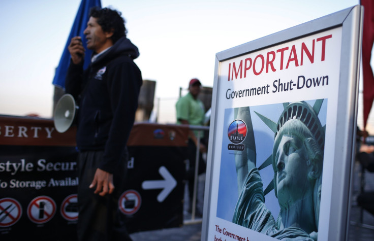 A man with a megaphone announces the closure of the Statue of Liberty to tourists in New York.