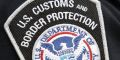 A US Customs and Border Protection badge.