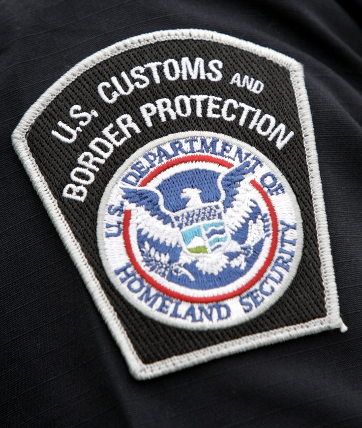 A US Customs and Border Protection badge.