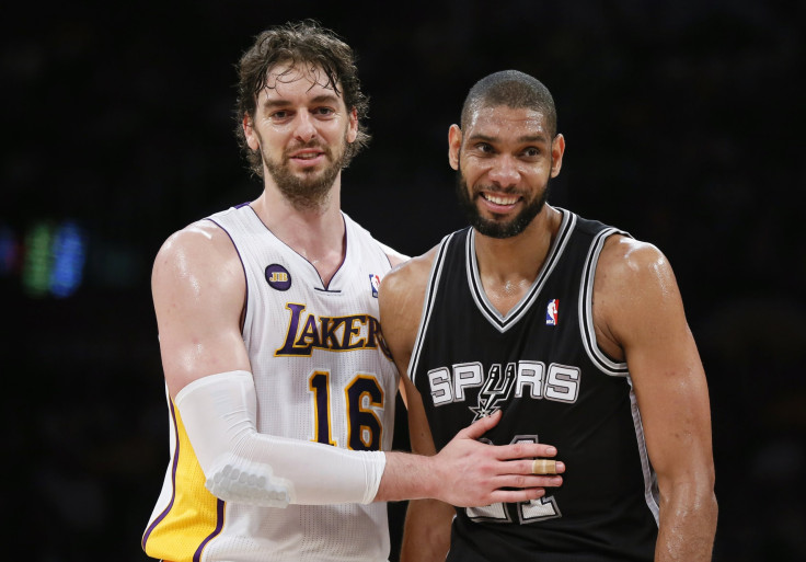 Spurs center Tim Duncan and Lakers center Pau Gasol share a moment of laughter on court.