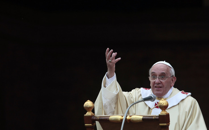 Pope Francis gestures while celebrating a mass on All Saints' Day at the Verano cemetery in Rome November 1, 2013. 