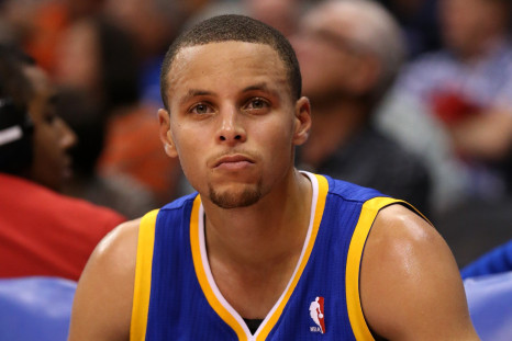 Stephen Curry #30 of the Golden State Warriors sits on the bench during the closing moments of the game with the Los Angeles Clippers at Staples Center.