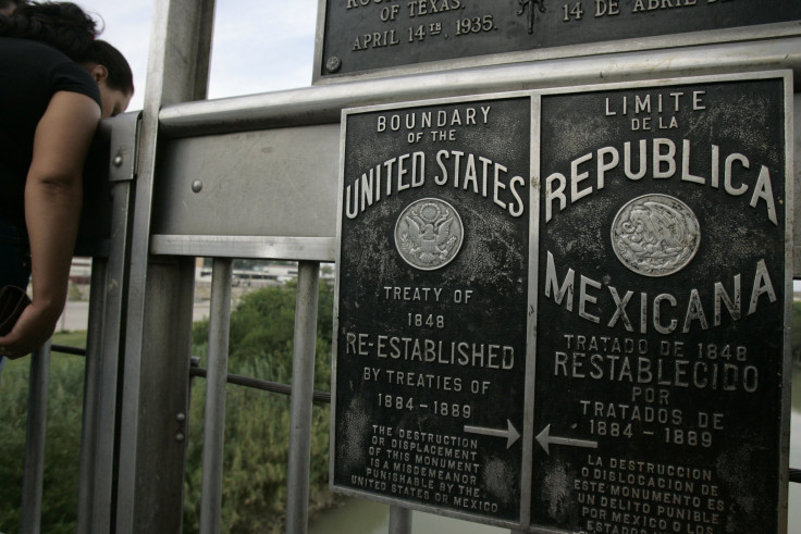 A sign on a cross-border bridge marking the border between the US and Mexico.