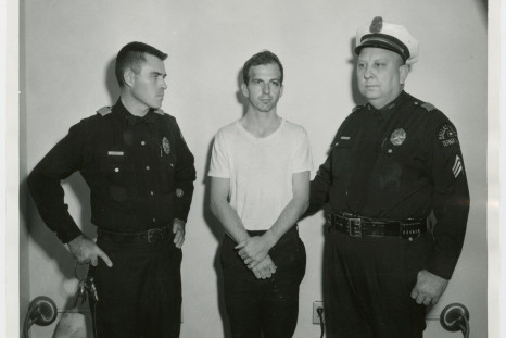Lee Harvey Oswald, accused of assassinating former U.S. President John F. Kennedy, is pictured with Dallas police Sgt. Warren (R) and a fellow officer in Dallas, in this handout image taken on Novembe