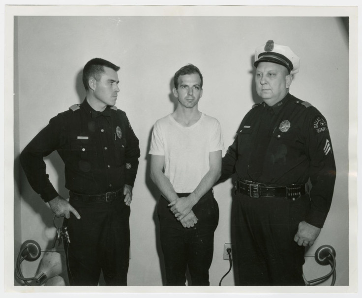 Lee Harvey Oswald, accused of assassinating former U.S. President John F. Kennedy, is pictured with Dallas police Sgt. Warren (R) and a fellow officer in Dallas, in this handout image taken on Novembe
