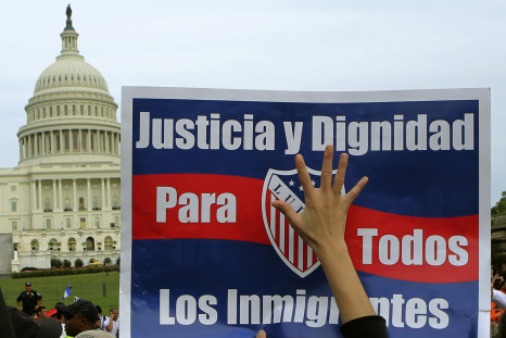 A woman holds up a sign during a protest rally for immigrants rights on Capitol Hill in Washington October 8, 2013.