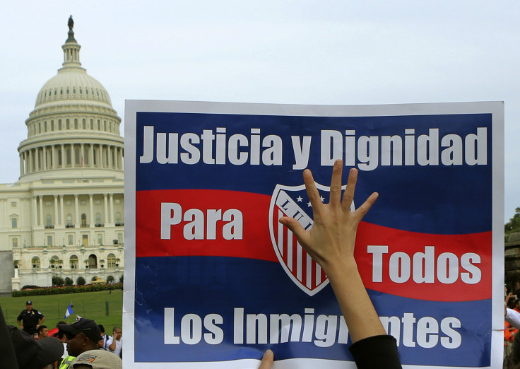 A woman holds up a sign during a protest rally for immigrants rights on Capitol Hill in Washington October 8, 2013.