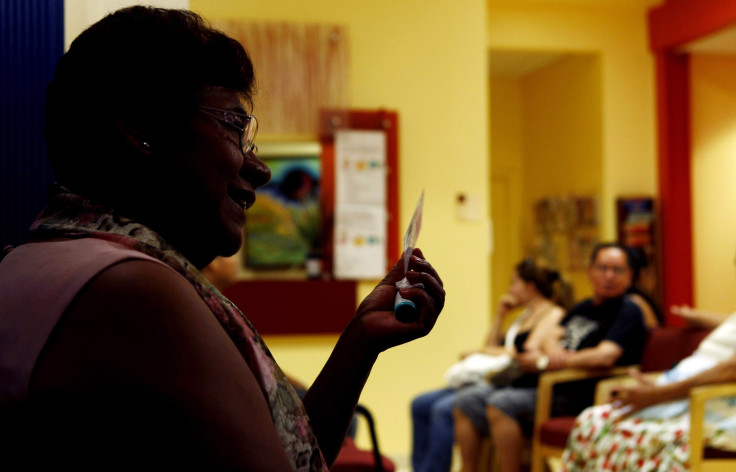 Paula, who asked to have her last name withheld, holds a membership card to the DC Health Care Alliance, as she is interviewed in La Clinica Del Pueblo health clinic in Washington in August 2012.