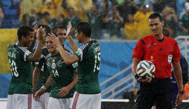 Mexico's players celebrate beating Cameroon
