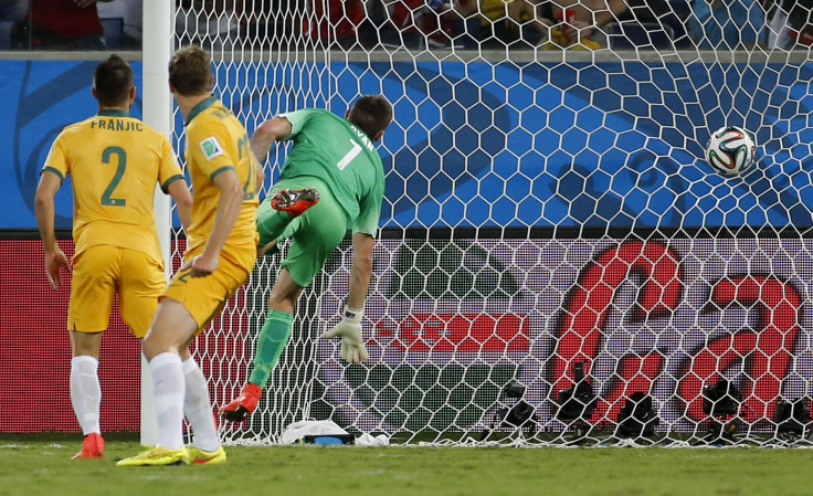 Australia's goalkeeper Mathew Ryan (R) fails to stop a goal