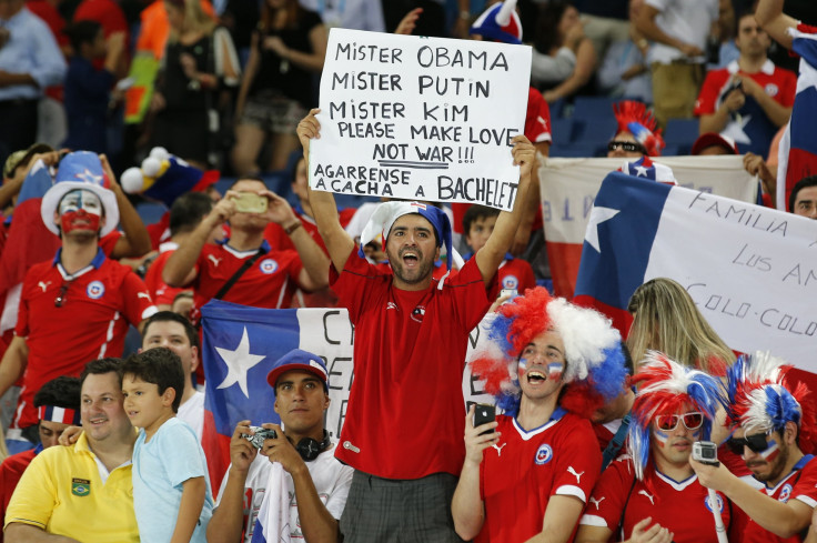 A Chile fan holds a sign 
