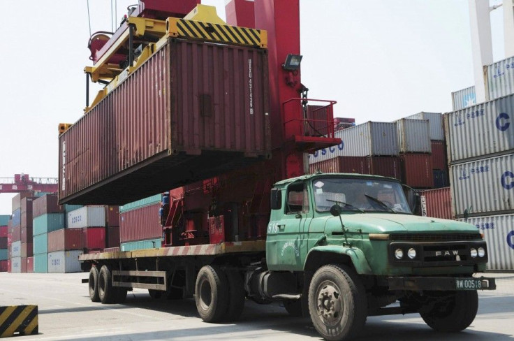 A crane loads a container onto a truck at a port in Qingdao, Shandong province.