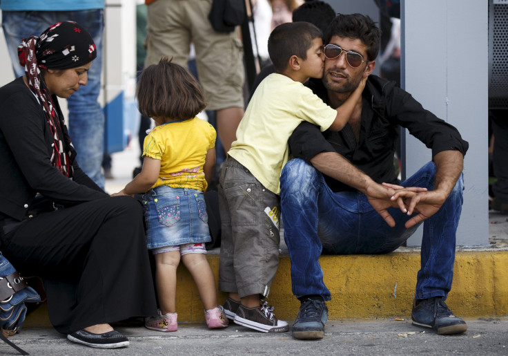 syrian boy kisses dad