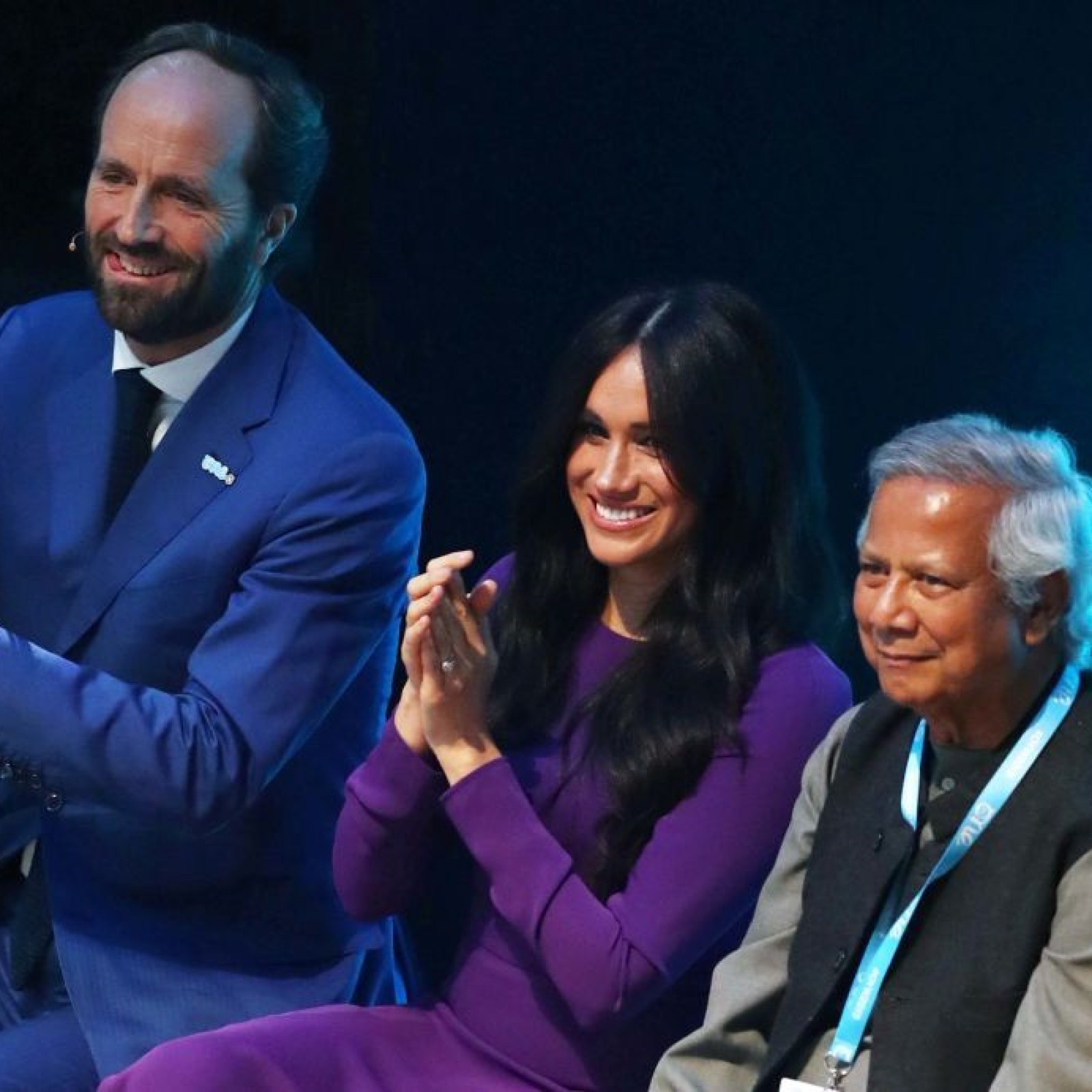 purple dress meghan markle Meghan Markle Wore a Thing: Burgundy Hugo Boss Dress En Route to New Zealand Edition