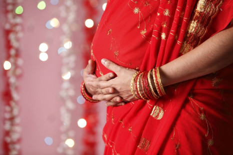 Close up of Indian woman touching her tummy