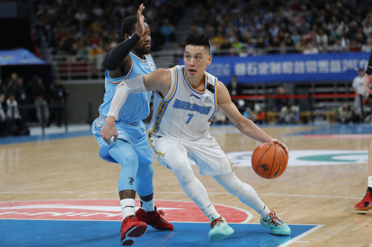 Jeremy Lin #7 of Beijing Ducks and Kay Felder #1 of Xinjiang Yilite