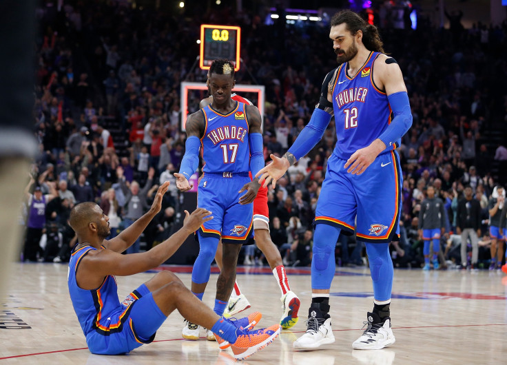  Chris Paul of the Oklahoma City Thunder is helped off the floor by Dennis Schroder and Steven Adams 