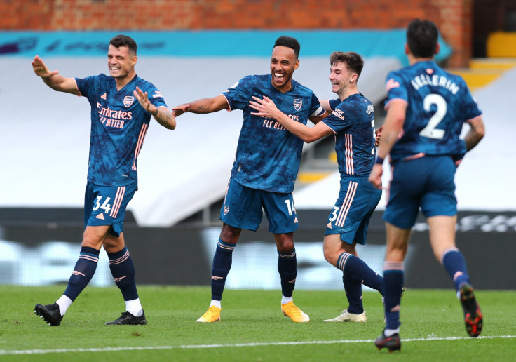 Pierre-Emerick Aubameyang of Arsenal celebrates with his team mates after scoring his team's third goal during the Premier League match between Fulham and Arsenal at Craven Cottage