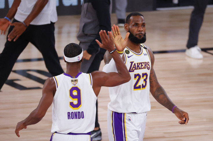 LeBron James #23 of the Los Angeles Lakers high fives Rajon Rondo #9 