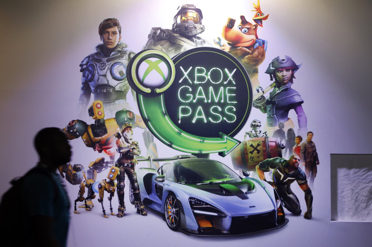  A visitor walks past an poster of the Microsoft subscription service "Xbox Game Pass"