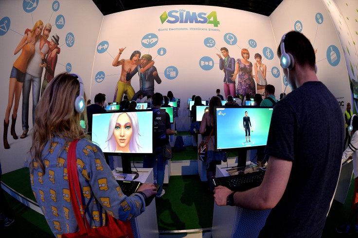 isitors try out the game 'SIMS 4' at the Electronic Arts stand at the 2014 Gamescom gaming trade fair 