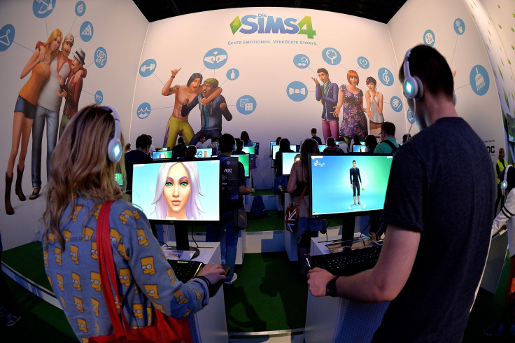 isitors try out the game 'SIMS 4' at the Electronic Arts stand at the 2014 Gamescom gaming trade fair
