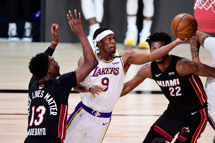 Rajon Rondo #9 of the Los Angeles Lakers drives to the basket against Jimmy Butler #22 of the Miami Heat and Bam Adebayo #13 of the Miami Heat