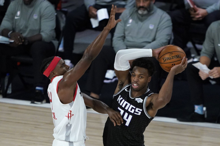 Buddy Hield #24 of the Sacramento Kings passes around the defense of Danuel House Jr. #4 of the Houston Rockets