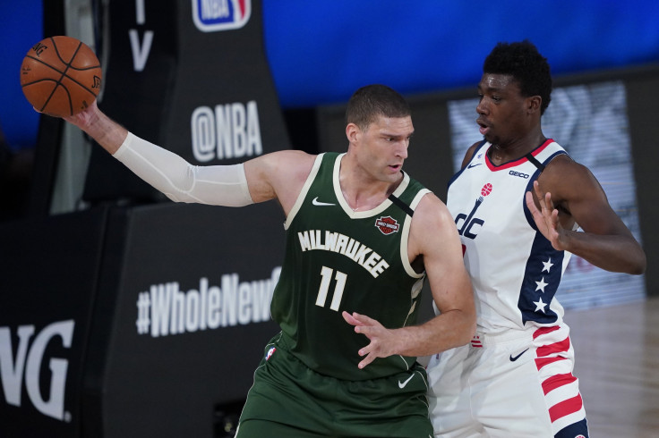  Brook Lopez #11 of the Milwaukee Bucks posts up against Thomas Bryant #13 of the Washington Wizards