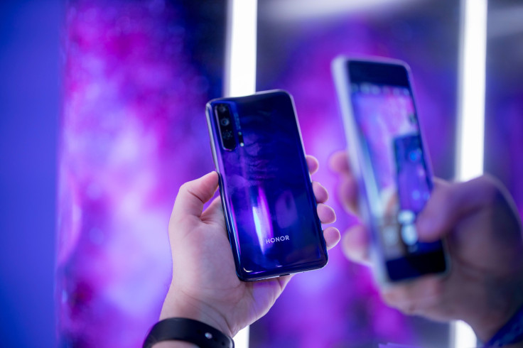 People take pictures of Honor 20 Pro smartphone at a launch event for the Honor 20 Series smartphones at Battersea Evolution in London