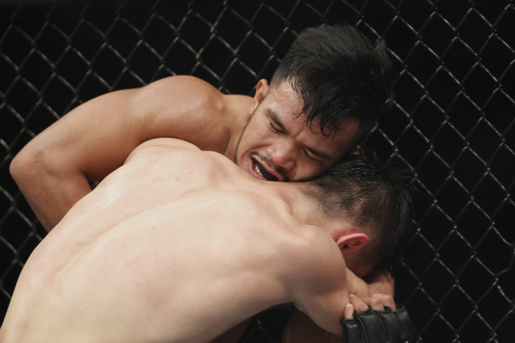Rolando Dy of Phillippines fights with Wuliji Buren during the UFC Fight Night at Mercedes-Benz Arena 
