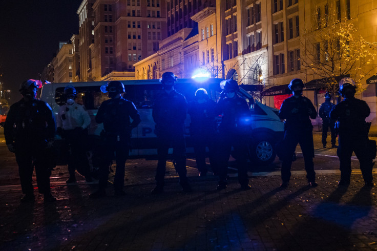 Police block off a street from an Antifa group prior to clashes with a group of Proud Boys following the "Million MAGA March"