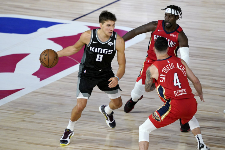 Bogdan Bogdanovic #8 of the Sacramento Kings drives against Jrue Holiday, back right, and JJ Redick #4 of the New Orleans Pelicans