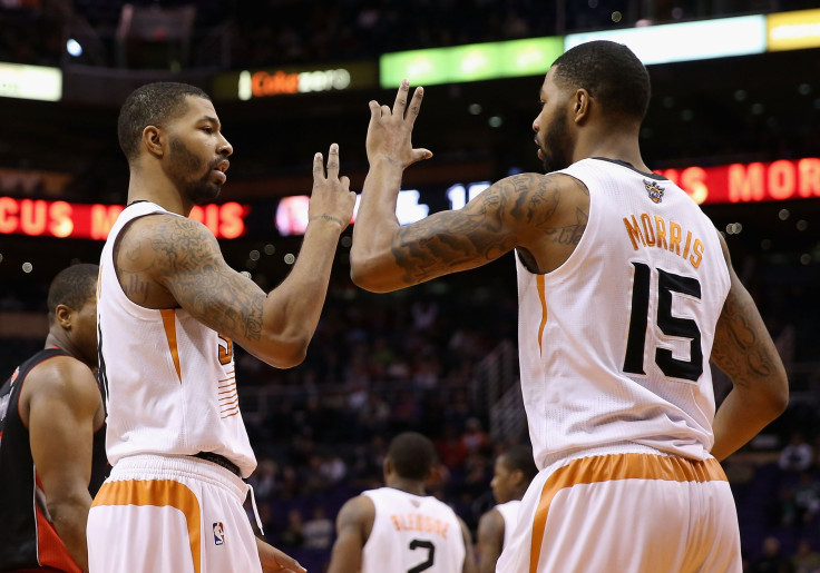 Markieff Morris #11 and Marcus Morris #15 of the Phoenix Suns