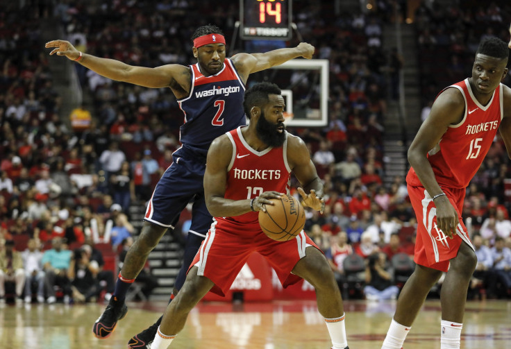 James Harden #13 of the Houston Rockets drives to the basket defended by John Wall #2 of the Washington Wizards