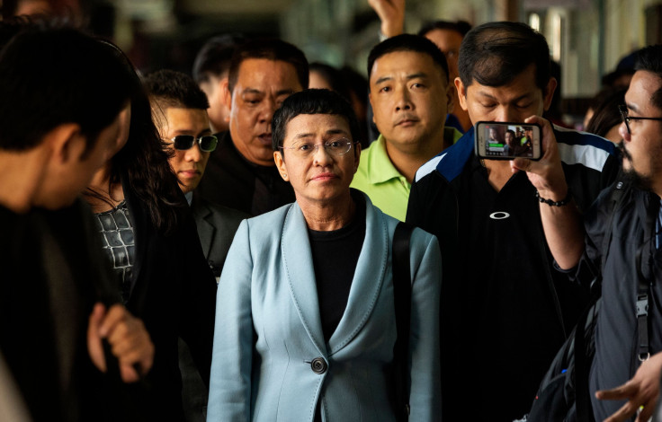 Philippine journalist Maria Ressa (C) arrives at a regional trial court in Manila